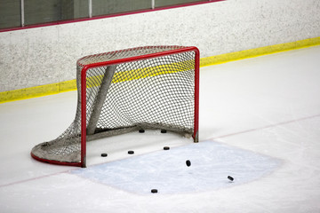 Hockey goal with hockey pucks