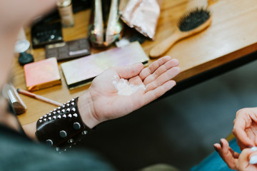 Makeup artist with translucent powder in his palm