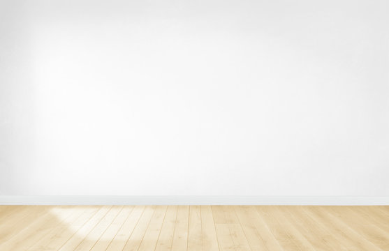 White wallpaper in an empty room with wooden floor