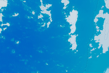 White blue and cyan background texture. Abstract map with north shoreline, sea, ocean, ice, mountains, clouds. View from height of the bird's flight. The surface of fantasy planet.