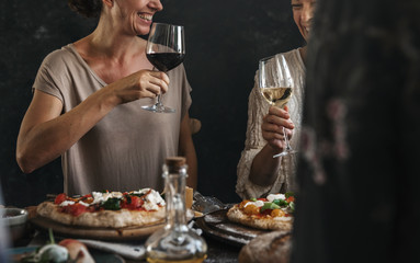 Happy women cheering with glasses of wine