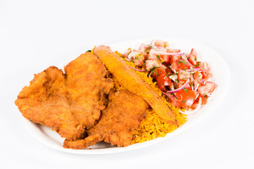 Ecuadorian national dish with rice, deep-fried fish, fried banana and vegetable salad 