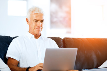 Fototapeta premium Man working on laptop at home