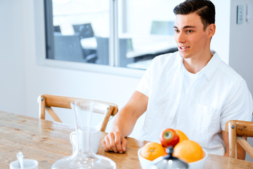 Portrait of a handsome young man in the kitchen