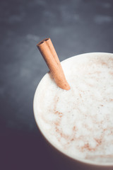 Sweet coffee with spices in cup on the rustic background. Selective focus.