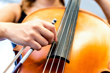 Close up of cello with bow in hands