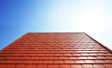 Red tile roof floor texture with cloud sky background. Closeup roofing pattern materials to build a house for sun and rain protection