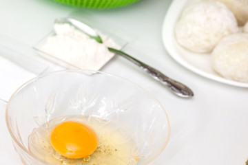 Preparation steps of traditional Colombian dish called stuffed potatoes: Preparing the egg and flour mixture to dunk potatoes