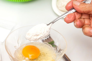 Preparation steps of traditional Colombian dish called stuffed potatoes: Preparing the egg and flour mixture to dunk potatoes