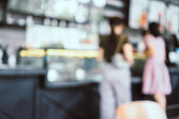 Blur coffee and restutant cafe with customers background.