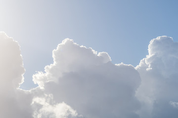 Dramatic cloudy sky, white and gray cumulus clouds moving across the blue sky, nature background