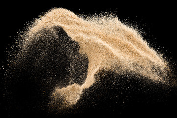 Sand flying explosion isolated on black background ,throwing freeze stop motion object design