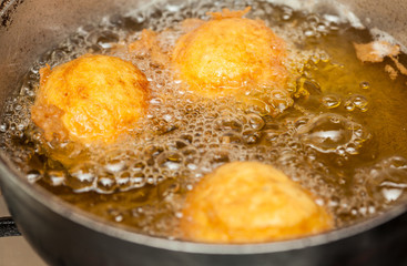 Preparation steps of traditional Colombian dish called stuffed potatoes : Deep frying stuffed pototoes