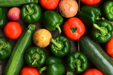 Cucumbers, tomatoes and sweet pepper on wooden table for background