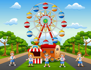 Obraz na płótnie Canvas Cartoon of school children having fun at amusement park