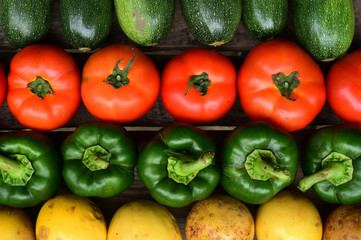Cucumbers, tomatoes and sweet pepper on wooden table for background