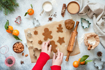 Fototapeta na wymiar Preparation of gingerbread cookies. Festive Christmas baking. Top view, flat lay composition. Woman baking cookies