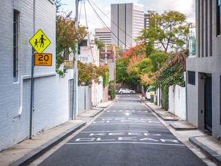 Laneway between suburban houses with speed limit sign on side. South Yarra, VIC Australia.