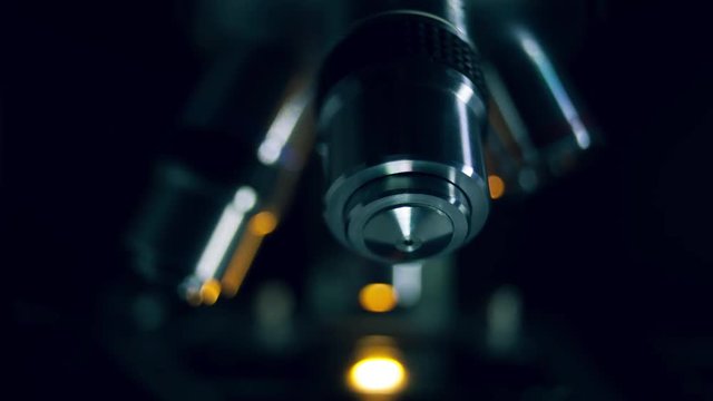 Optical Microscope in dark backround. Microscope is used for conducting planned, research experiments, educational demonstrations in medical and clinical laboratories.