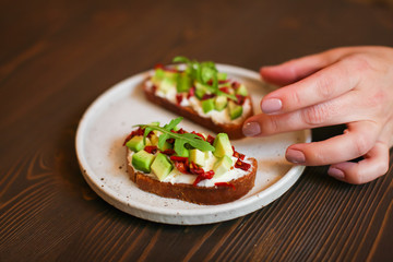 freshly prepared sandwiches with avocado, rye bread, tomatoes, concept of healthy food, nutrition and omega fatty acids