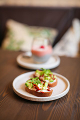 freshly prepared sandwiches with avocado, rye bread, tomatoes, concept of healthy food, nutrition and omega fatty acids
