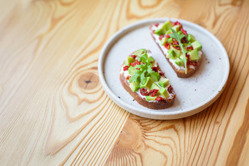 freshly prepared sandwiches with avocado, rye bread, tomatoes, concept of healthy food, nutrition and omega fatty acids