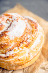 Fresh sweet bun on the rustic wooden background. Selective focus.