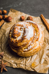 Fresh sweet bun on the rustic wooden background. Selective focus.