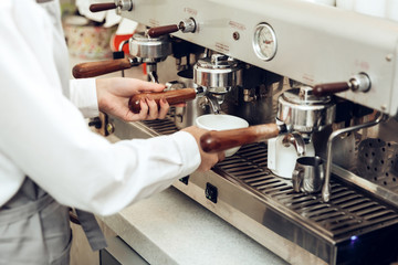 Close up of female barista preparing coffee