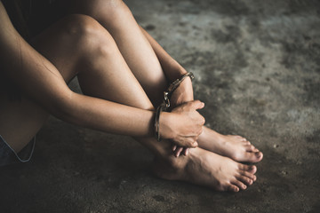 close-up of hands in handcuff,  Female prisoner, Arrested woman handcuffed hands. Prisoner or...