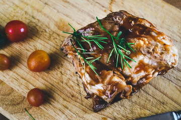 Hot and spicy barbeque racks of pork on wood dish.