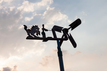 Wind turbine made by wood on nature white cloud and blue sky background.