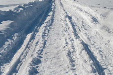 Fototapeta na wymiar Snowy road, sunny winter day