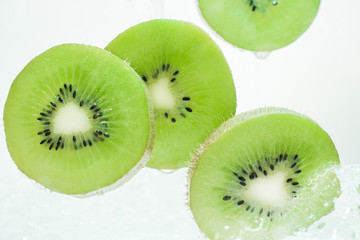 Slices of fresh kiwi in clear water.