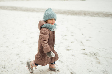 Winter Walk of small pretty ruddy girl