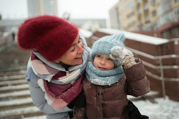 Happy mother and daughter playing outside.