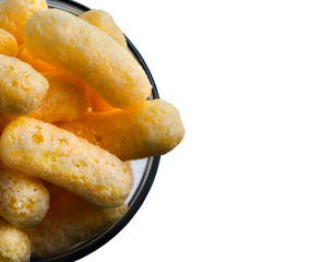 Corn Puffs in a Glass Bowl Isolated On White Background. Crunchy Flavored Puffed Snacks. Party, Movie Snacks.