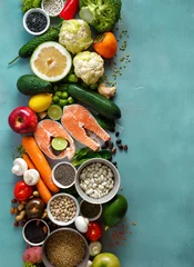 Photo sur Plexiglas Manger healthy food diet cereals seeds fish vegetables fruits stone background top view