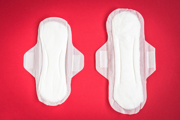 Woman hygiene protection on red background. Sanitary pads.