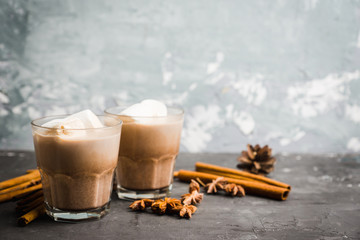 Sweet hot chocolate in glass. Christmas drink with spices and marshmallow. Selective focus. Shallow depth of field. 