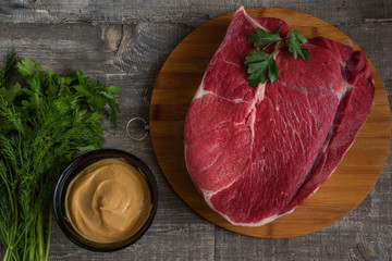 Flat lay. Pieces of raw cow steak. Fresh and raw meat on wood desk. Cow chops uncooked, uncut ready...