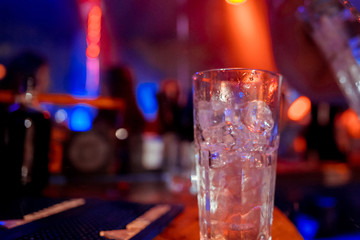 Iced water glass on table