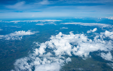 Clouds seen from an airplane, blue sunshine, soil background nature landscape