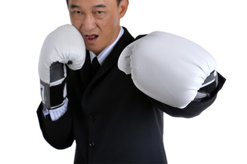 Businessman wearing boxing gloves acting  punching like business have competition all time