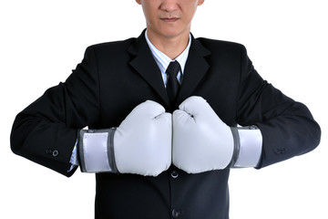 Businessman wearing boxing gloves acting  punching like business have competition all time
