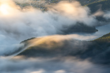 Morning mist over Kawaguchi lake closed to Fuji mountain