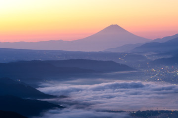 Fototapeta premium View of Mount Fuji and Sea of mist above Suwa lake in morning from Takabochi Highland, Mountain Takabochi, Nagano prefecture, Japan.