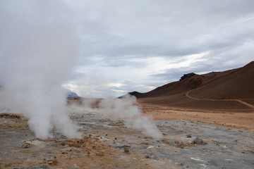 Geothermal fields Iceland Europe. Geysers and fumaroles emit white cloud of steam