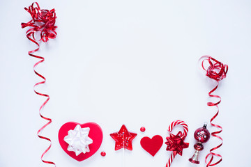 Red Christmas decorations and sweets on the white  background. Space for a text. Top view. Flat lay.