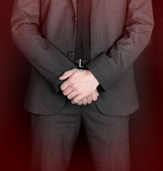 Businessman standing with hands folded